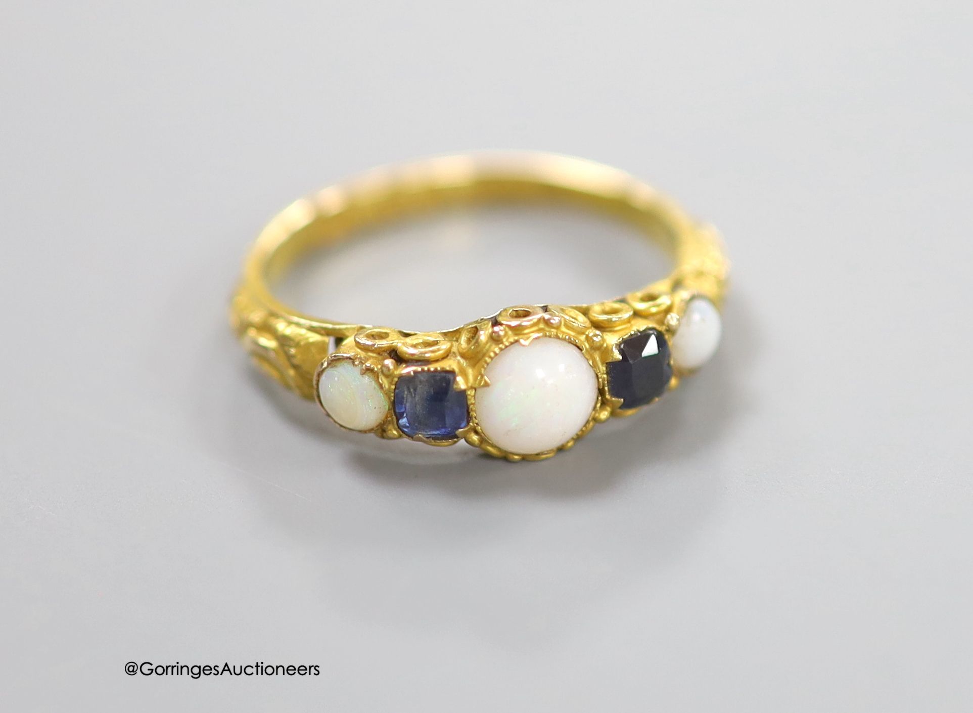 A Victorian 15ct gold, three stone white opal and two stone sapphire set half hoop ring, size L/M, gross 1.4 grams.